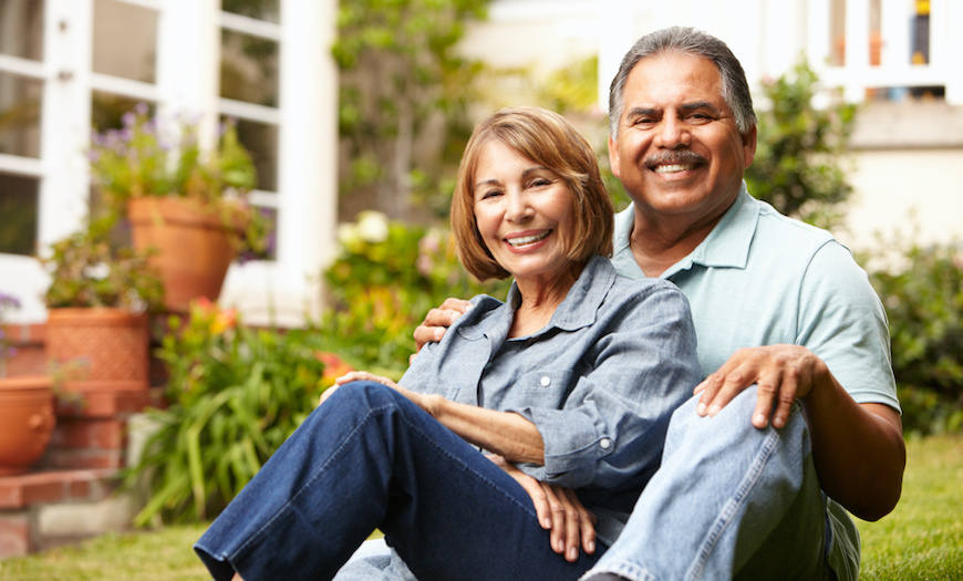 Older couple in front of a house