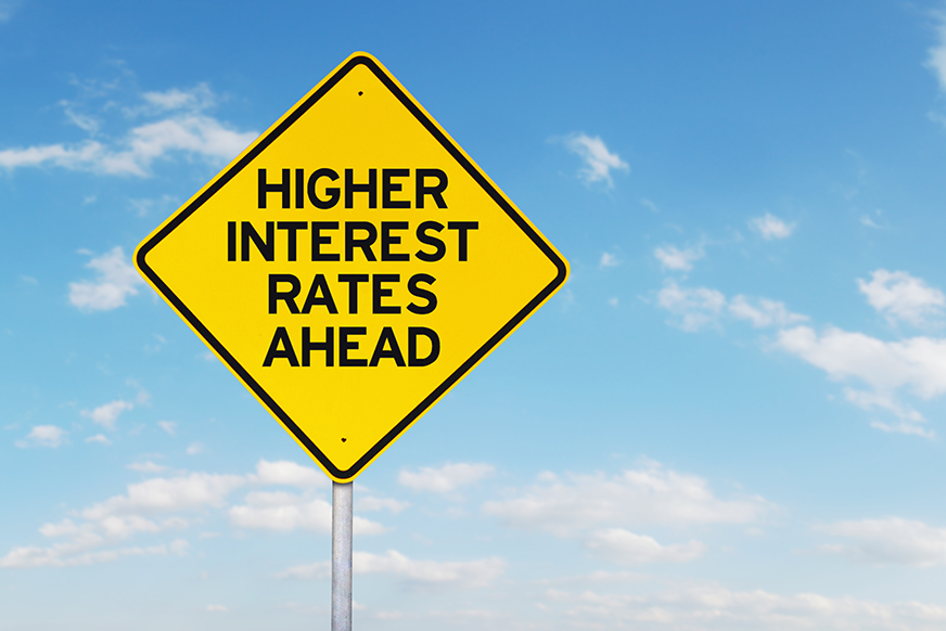 road sign that reads: "higher interest rates ahead"